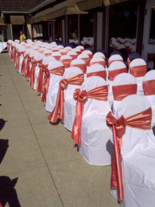 Coral Taffeta Sashes for an outdoor summer wedding ceremony.