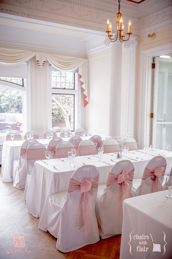 Pink & Latté organza sashes on white banquet chair covers